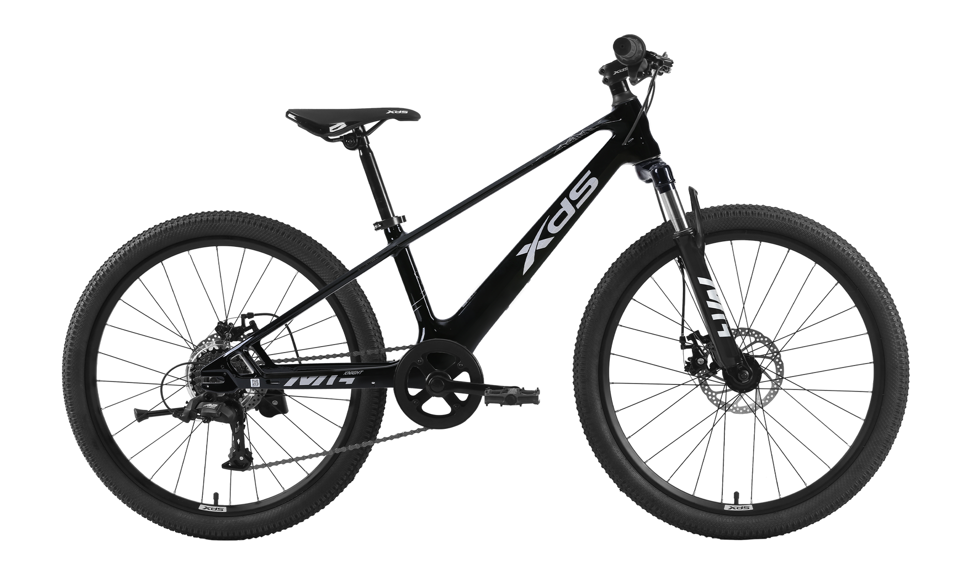 A side-view studio shot of a black XDS 20-inch children's mountain bike with a matte black frame, white XDS branding, front suspension fork, mechanical disc brakes, and rugged off-road tires against a dark, transparent background.